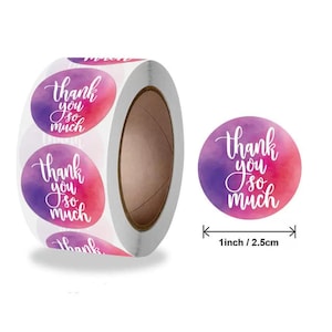 May include: A roll of round stickers with a watercolor design in shades of pink and purple. Each sticker has the words "Thank you so much" in white script. The stickers are 1 inch (2.5 cm) in diameter.