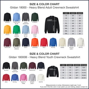 The image is a size and color chart for a Gildan 180000 - Heavy Blend Adult Crewneck Sweatshirt. It displays a variety of different colored shirts in sizes ranging from S to M, including black, blue, green, orange, red, royal, and grey. The chart provides measurements for each shirt size and color, allowing customers to choose the desired combination.