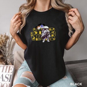 May include: A set of three ceramic mugs with a speckled, cream-colored glaze. Each mug features a different hand-painted design: a sun, a moon, and a star. The mugs have a minimalist, modern aesthetic.