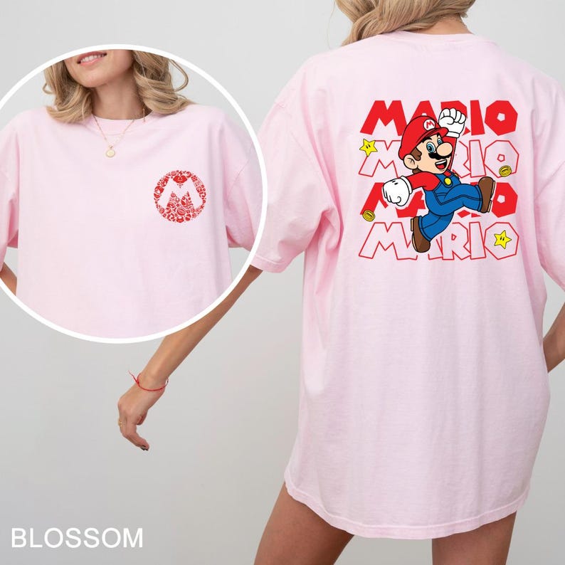 A woman wearing a pink t-shirt with a Mario character printed on it.