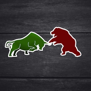 May include: A green bull and a red bear are depicted in a sticker design, facing each other in a stance of conflict. The bull is charging forward, while the bear stands on its hind legs. The image is set against a dark wood grain background.