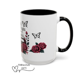May include: White ceramic mug with a black interior and handle. The mug features a design of red roses, butterflies, and the text "Inspirational Pages". The words "Fabulous Gift!" are also included.