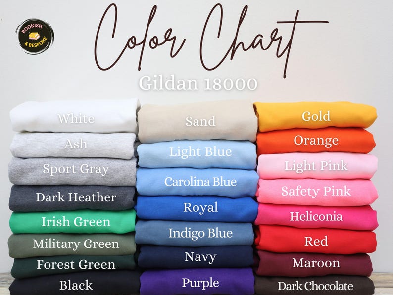 以下が含まれることがあります： さまざまな色のGildan 18000のスウェットシャツが折りたたまれたカラーチャート。白、アッシュ、スポーツグレー、ダークヘザー、黒など。チャートには「Color Chart」の文字も含まれています。