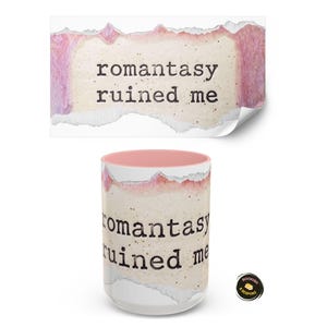 May include: A white ceramic mug with a pink interior and the text "romantasy ruined me" printed on it. The design features a torn paper effect with pink and beige tones. A matching sticker is above the mug.