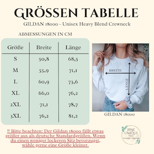 May include: A size chart for a Gildan 18000 unisex heavy blend crewneck sweatshirt. The chart displays measurements in centimeters for sizes S through 3XL, including width and length. An image shows the sweatshirt with arrows indicating width and length.