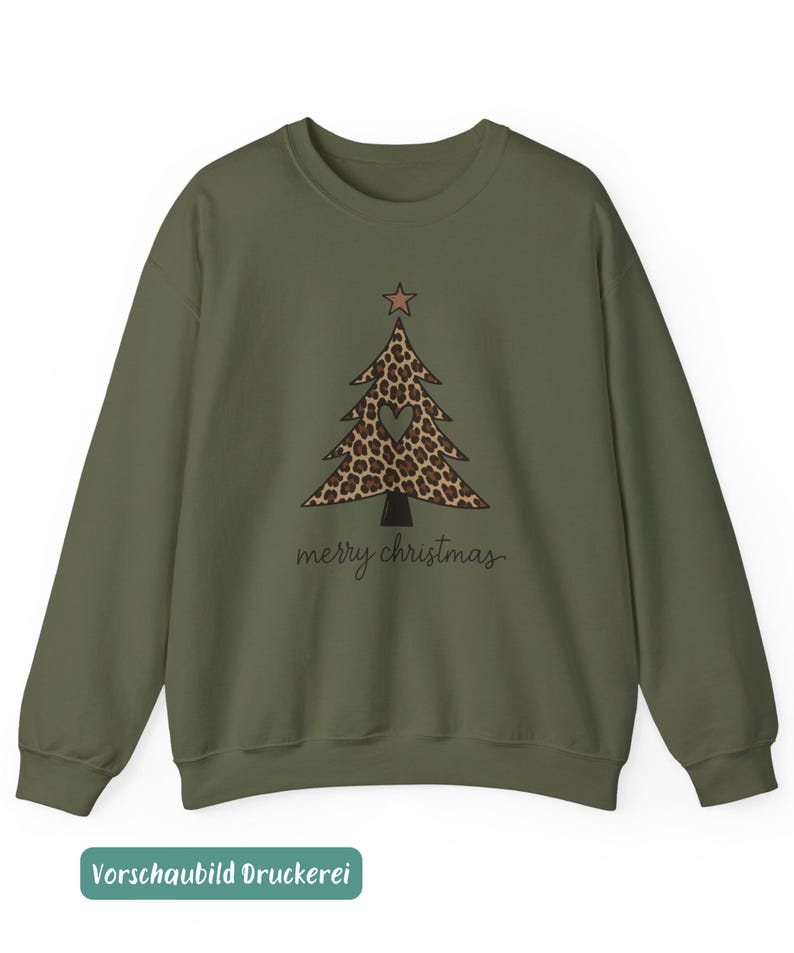 May include: An olive green crewneck sweatshirt featuring a central graphic of a Christmas tree with a brown leopard print pattern, a small star at the top, and a heart-shaped cutout in the center. The text merry christmas is printed below.