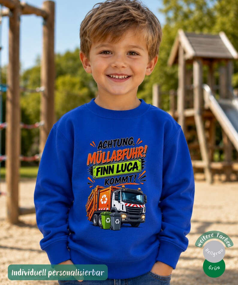 May include: A royal blue long-sleeve sweatshirt featuring a graphic of an orange garbage truck with two small trash bins. The text reads ACHTUNG, M&Uuml;LLABFUHR! FINN LUCA KOMMT! in orange, green, and black lettering with decorative orange accents.