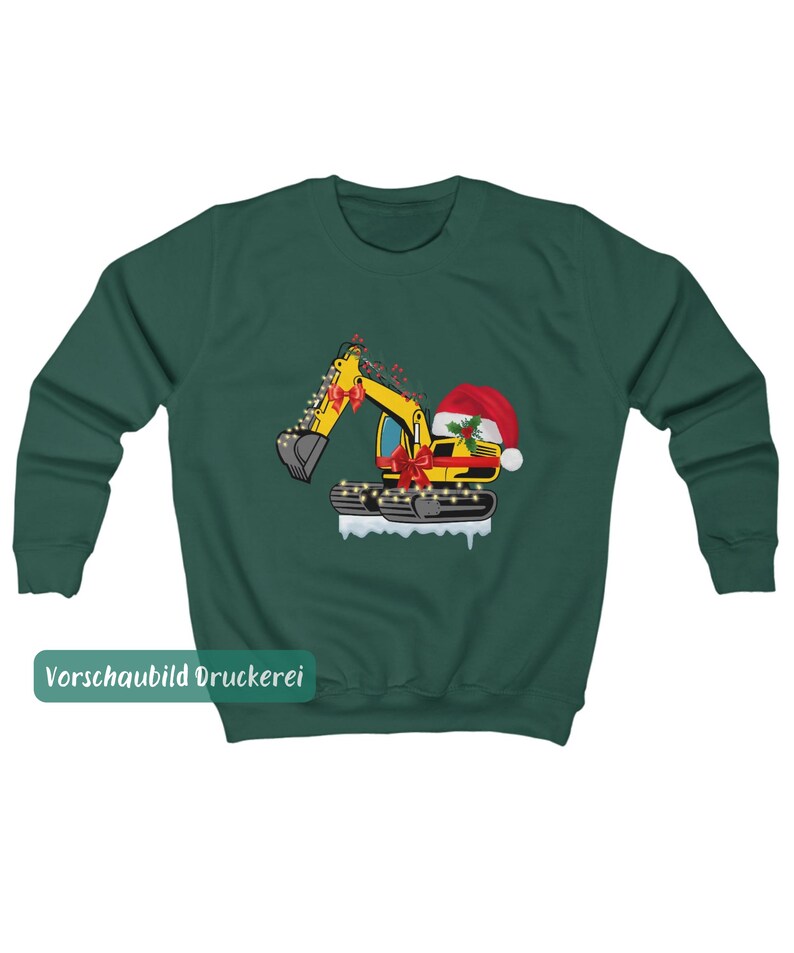 May include: A dark green crewneck sweatshirt featuring a graphic of a yellow excavator decorated with red bows, string lights, and a Santa hat. The excavator sits on a white snowy base, and the text "Vorschaubild Druckerei" appears in a green box.