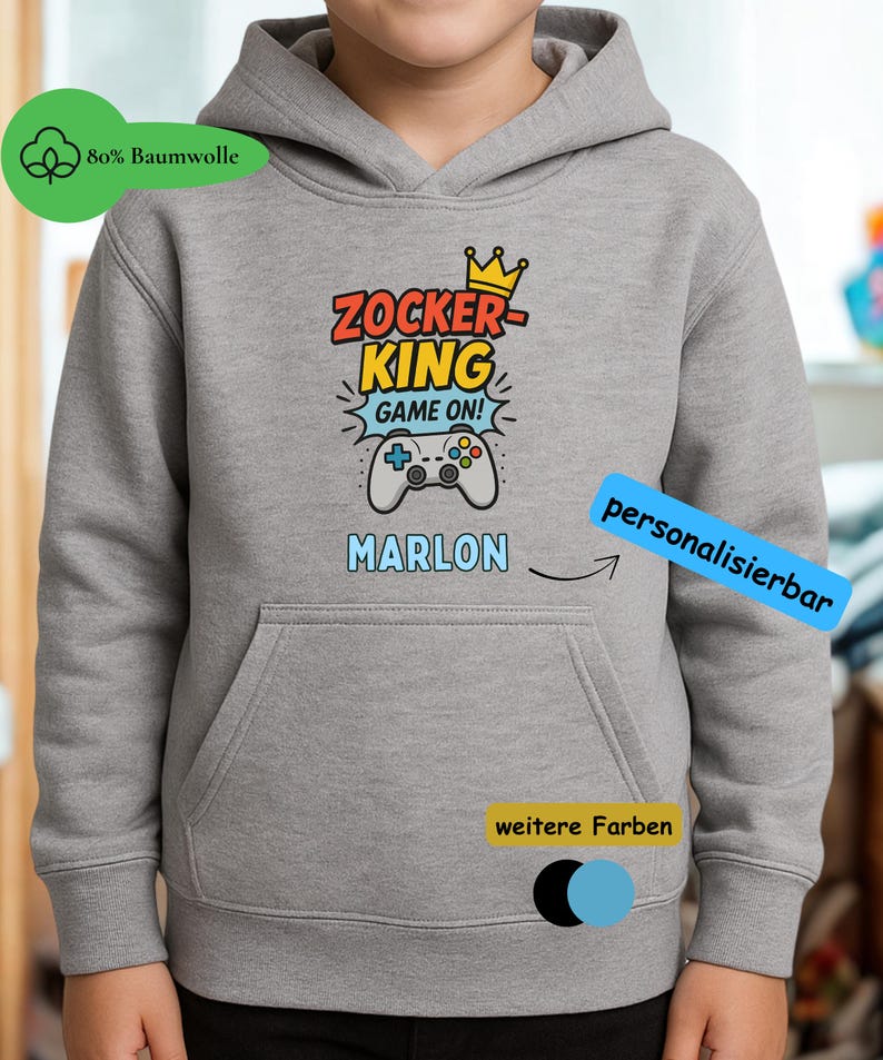 May include: A heather gray hooded sweatshirt featuring a graphic print with the text ZOCKER KING GAME ON, a yellow crown, and a game controller. The name MARLON is printed below the graphic in light blue letters on the front of the garment.