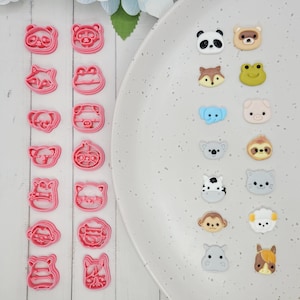 May include: A selection of pink animal-shaped cookie cutters and animal-themed embellishments. The cookie cutters include panda, fox, koala, pig, monkey, and tiger shapes. The embellishments include panda, fox, frog, pig, koala, sloth, and cat shapes.