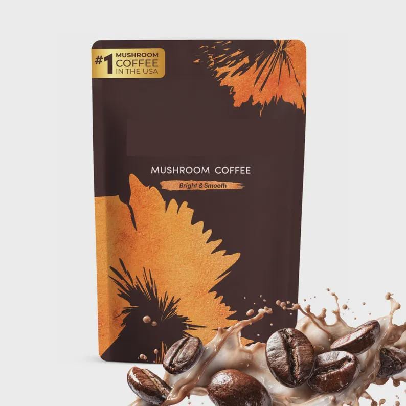 May include: A dark brown bag of mushroom coffee with the text "Mushroom Coffee" and "Bright & Smooth". The bag has a gold label that says "#1 Mushroom Coffee in the USA". Coffee beans and a splash of coffee are in the foreground.