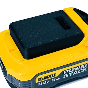 May include: A yellow and black DeWalt 20V 5Ah lithium-ion battery with the text "POWER STACK" printed on it.
