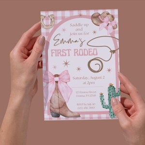 May include: A pink and white gingham-patterned invitation with the text "Emma's First Rodeo." The invitation features illustrations of a cowboy hat, horseshoe, rope, and a cowboy boot with a pink bow. The event details are also included.