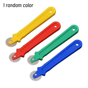 May include: Four sewing tracing wheels with plastic handles in yellow, red, green, and blue. Each tool features a serrated metal wheel at the tip and a hole at the end of the handle. The text 1 random color is visible in the upper left corner.