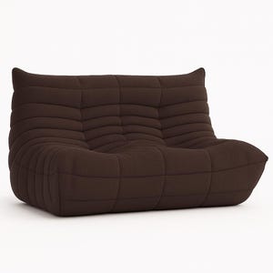 May include: A brown, two-seater sofa with a low profile and a rounded shape. The sofa features a quilted design with horizontal stitching, creating a textured appearance. The cushions are soft and inviting, perfect for lounging.