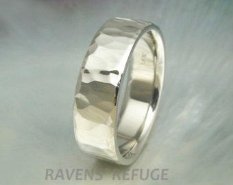 May include: A silver hammered wedding band with a 14K marking on the inside of the band.
