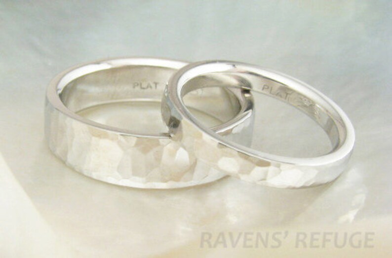 May include: Two platinum wedding bands with a hammered finish. The bands are stacked on top of each other and the inside of each band is stamped with "PLAT".