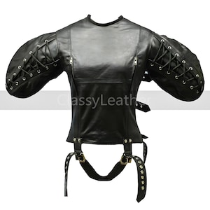 May include: Black leather jacket with long sleeves and a lace-up design on the cuffs. The jacket has a zipper closure and a belt at the waist.