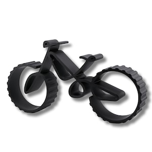 Geometric bicycle sculpture with hollow frame and thick ridged wheels, viewed from a low angle front right on a white background. Visible layering texture along edges and smooth curved surfaces.