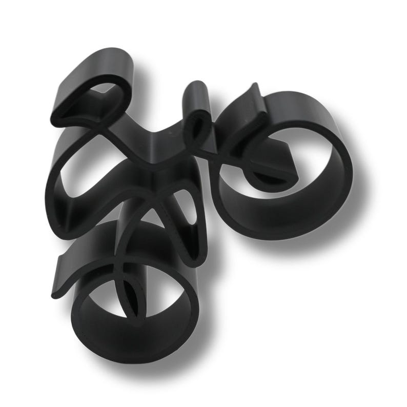 Minimalist cyclist sculpture in a continuous line style, manufactured from plastic and displayed from a direct front angle to emphasize its balanced structure and modern design.