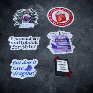 May include: Six vinyl stickers featuring book-themed designs. One shows a purple potion bottle labeled Violence Apothecary, a red warning circle, a stack of purple books with wings, and three stickers with text: I paused my audiobook for this?, But does it have dragons?, and When I die, delete my kindle history.