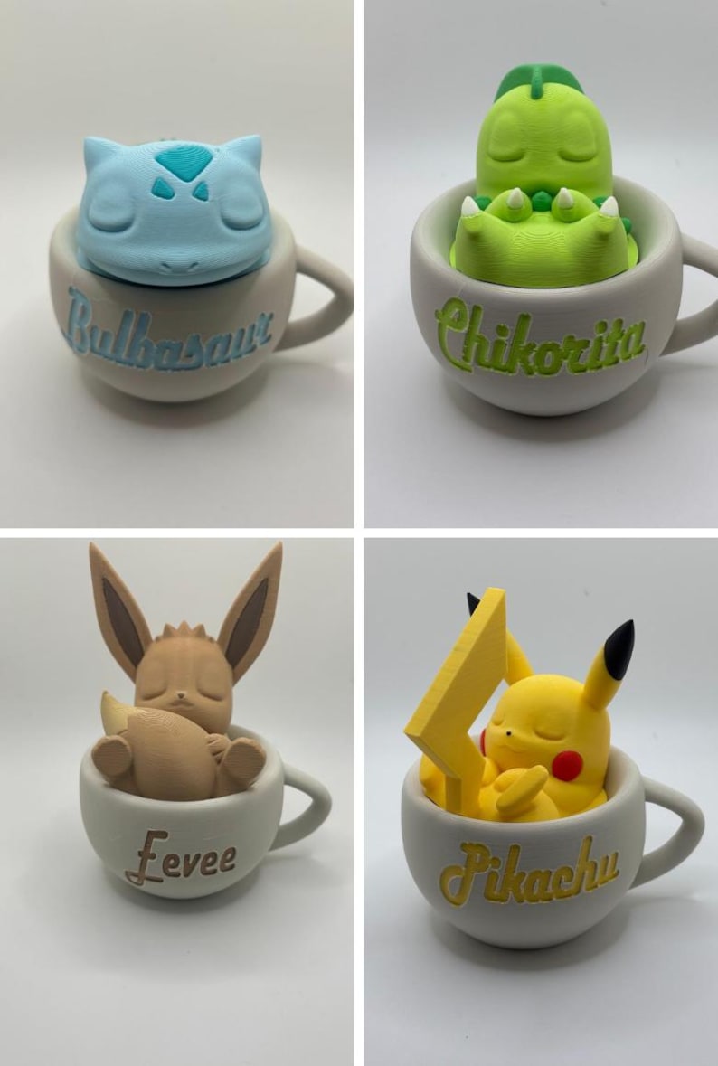 May include: Four ceramic mugs, each featuring a different Pok&eacute;mon character. The mugs are light gray with the character's name written on the side. The characters include Bulbasaur, Chikorita, Eevee, and Pikachu, each in a sleeping pose.