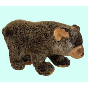 May include: A plush bear toy covered in textured dark brown fur with lighter brown accents on the ears and snout. The stuffed animal is depicted in a standing position, featuring a rounded body, short limbs, and a soft, fuzzy exterior texture.