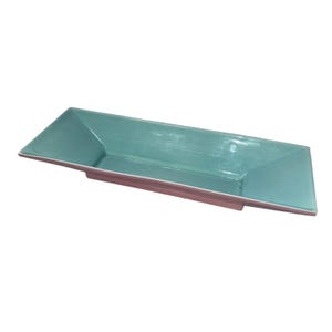 May include: A rectangular serving dish with a teal interior and a brown base. The dish has a simple, modern design and is suitable for serving appetizers or small dishes. The dish is approximately 12 inches long and 5 inches wide.