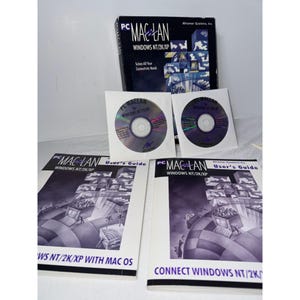May include: A PC MacLan software package for Windows NT/2K/XP. The set includes a black box, two CDs in white sleeves, and two user guides. The box and guides feature the MacLan logo and product information.
