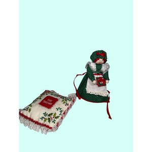 May include: A Christmas-themed decorative pillow and doll. The pillow is white with red trim, lace, and embroidered holly. The text "FOR TEACHER" is in a red square. The doll wears a green polka-dot dress and apron.