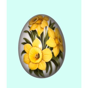 May include: An egg-shaped decorative item with a painted design of yellow daffodils and green leaves. The egg has a light gray base color and is set against a light blue background. The daffodils are in full bloom.