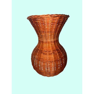 May include: A medium brown woven wicker vase featuring a rounded base that tapers into a narrow neck before widening at the top rim. The structure is composed of thin, interlaced natural fibers creating a consistent, textured basket weave pattern.