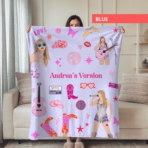 May include: A light purple blanket featuring illustrations of a singer, musical notes, cowboy boots, and hearts. The blanket has the text "Andrea's Version" and other graphics. The word "LOVE" is also visible on the blanket.