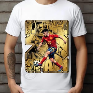 May include: White t-shirt featuring a graphic of a soccer player in a red and blue uniform kicking a soccer ball. The graphic includes the text "PEREZ SPAN" in a gold, outlined font.