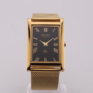 Vintage Seiko Slim Tank Watch: Black Dial, Gold Case, Stainless Steel Bracelet