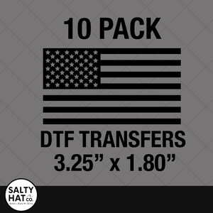 May include: A 10-pack of DTF transfers featuring a black and white American flag design. The transfers measure 3.25" x 1.80". The image includes the text "10 PACK" and "DTF TRANSFERS".