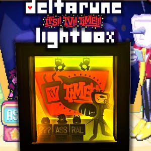 May include: A black framed lightbox with a design from the video game Deltarune. The lightbox has a yellow and orange illuminated interior with the words "TV TIME" and a character silhouette. The top of the frame reads "Deltarune It's TV Time!! Lightbox".