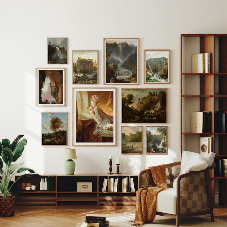 May include: A gallery wall featuring nine framed landscape paintings in various styles. The paintings depict scenes of nature, including waterfalls, mountains, and forests. The paintings are arranged in a grid pattern on a white wall.