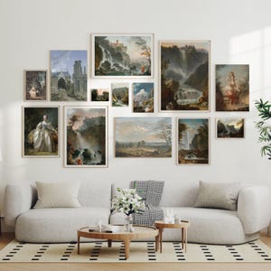 May include: A gallery wall featuring a collection of framed landscape paintings. The paintings depict various scenes of nature, including waterfalls, forests, and mountains. The paintings are arranged in a grid pattern on a white wall.