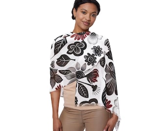 May include: A white shawl with a black and burgundy floral pattern. The shawl features large stylized flowers and leaves. The edges are fringed. The shawl is draped over the shoulders.