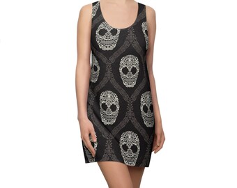 May include: A black sleeveless dress with a white skull pattern. The skulls are ornate and have a lace-like design. The dress is fitted and has a scoop neck.