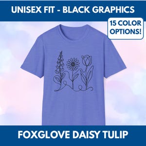 May include: A periwinkle blue unisex t-shirt with a black line drawing of a foxglove, daisy, and tulip. The shirt has the text "UNISEX FIT - BLACK GRAPHICS", "15 COLOR OPTIONS!", and "FOXGLOVE DAISY TULIP".