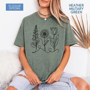 Camiseta gráfica FDT con estampado sutil de margaritas y tulipanes de dedalera / Camiseta de activismo político floral (colores jaspeados)