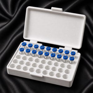 Premium white peptide vial storage box on black satin with blue-capped vials