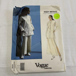 May include: A Vogue Patterns sewing pattern featuring an Issey Miyake design. The pattern shows a two-piece outfit: a long-sleeved jacket with pockets and wide-leg pants. The pattern is labeled "1541" and includes sizes 6-8-10.