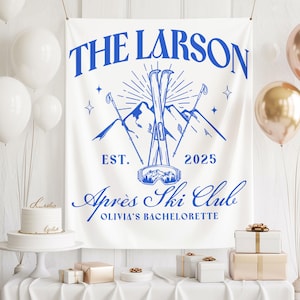 May include: White banner with blue text and a ski-themed design. The banner reads "THE LARSON EST. 2025 Après Ski Club OLIVIA'S BACHELORETTE" with illustrations of skis, mountains, and goggles. Balloons and gifts are in the background.