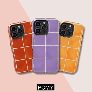 May include: Three phone cases in shades of orange, purple, and yellow, each with a tile design and white grout lines. The cases have a glossy finish and a camera cutout. The text "PCMY" is at the bottom.