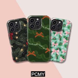 May include: Three phone cases with Christmas-themed designs. One case features a dark green background with Christmas tree branches and red bows. Another has a green background with a garland of lights and orange bows. The third case has a light green background with pink bows and sprigs.