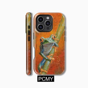 May include: A phone case with a vibrant orange and brown background featuring a green and blue frog with orange eyes perched on a branch. The case has a black border and a camera cutout.