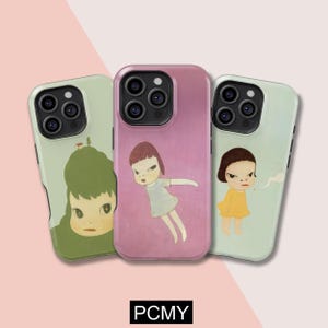 May include: Three phone cases with unique illustrations. The cases feature artwork of cartoon-like figures in various poses and colors, set against a light green and pink background. The text "PCMY" is at the bottom.